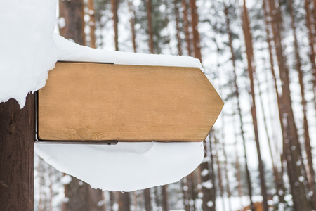 Wooden sign with snow on itの写真素材