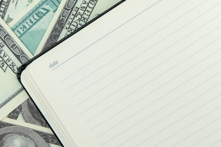 Notebook on dollar bills backgroundの写真素材