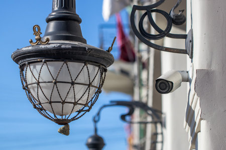 Vintage lantern close-up on buildings facade over blue sky