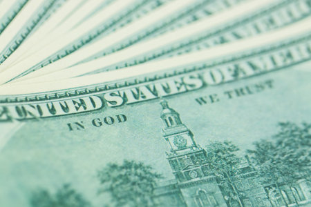 close-up 100 US dollar bills with in God we trust text. Background