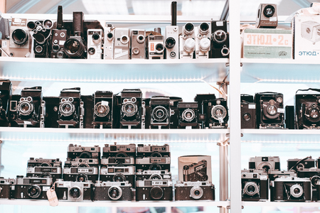 White shelf full of old vintage photo camerasの写真素材