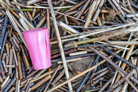 pink plastic cup thrown on the ground. Concept of litteringの写真素材
