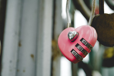 Red love padlock locked on bridge. Symbol of marriage and eternal love