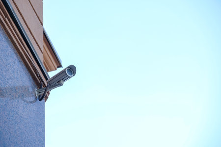 Security camera on a building over blue sky
