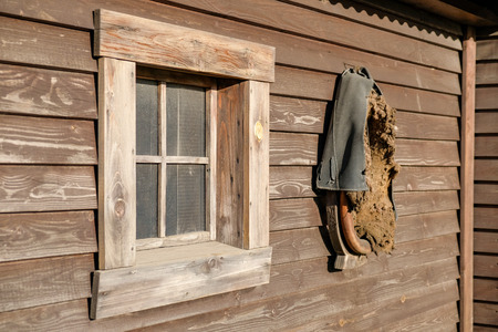 The facade of a wooden house with a window.の写真素材