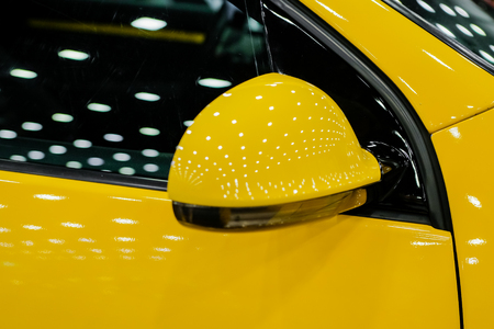 Close-up of side mirror of a yellow sports car.の写真素材