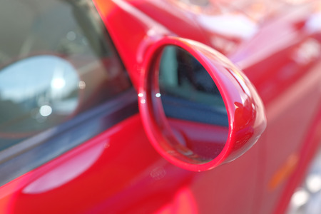 Close-up of side mirror of a red sports car.の写真素材
