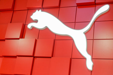 RUSSIA, ST.PETERSBURG - May 05, 2018: Glowing white logo of Puma on a red design background.のeditorial素材