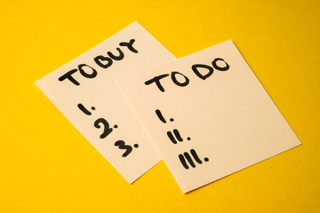 Concept tasks for the day what to buy and do. Yellowish stickers with inscriptions on a yellow background.の写真素材