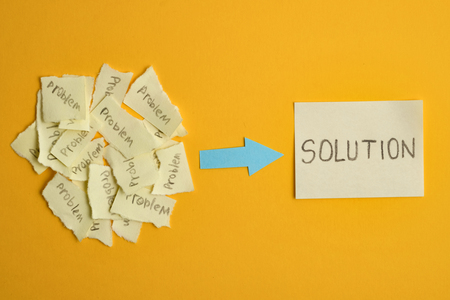 The concept of the found solution from a set of unsolved problems. Ripped stickers with the word "problem" with a sticker that says "solution" on a yellow background.の写真素材