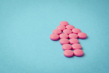 Arrow from pink pills pointing to the top on a blue background. Toned