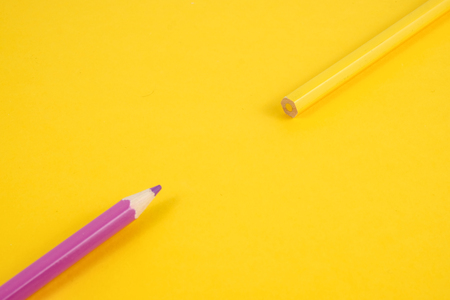 The concept of the birth of ideas. Yellow and purple pencil on a yellow background.の写真素材