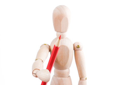 The concept of human artist. Wooden man hold red pencil on a white background.の写真素材