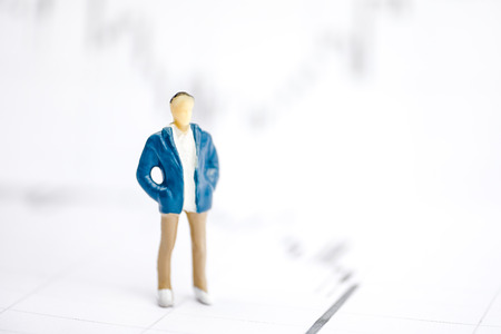 The concept of a young businessman. Human model on the background of graphs.の写真素材