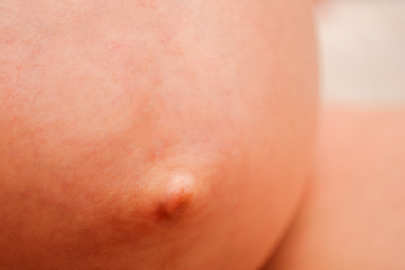 The tummy of a pregnant girl in the ninth month. Close up.の写真素材
