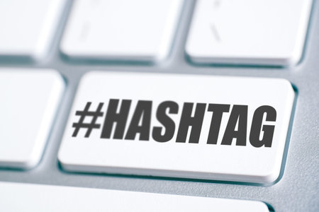 The word hashtag and its sign on the white keyboard key.