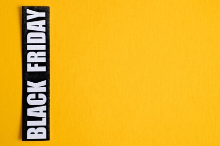 Black Friday sticker on a yellow background. Close up. Copy space.の写真素材