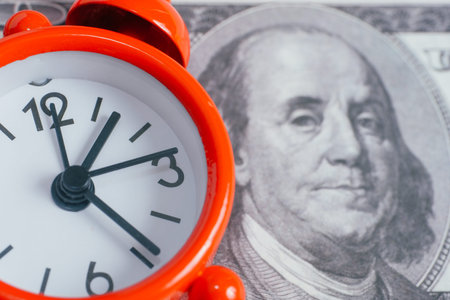 Concept of making money. Vintage watches on hundred dollar bills. Close up.の写真素材