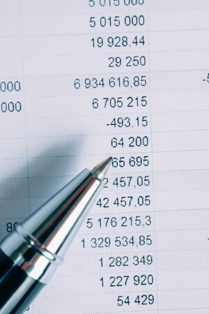 Pen on paper background with totals. Toned. Vertical.の写真素材