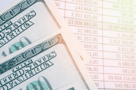 hundred dollars on paper background with totals and flare.の写真素材