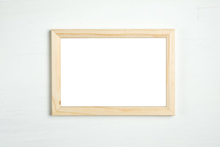 wooden frame on a white wooden background. Moke up. Top view. Copy space.