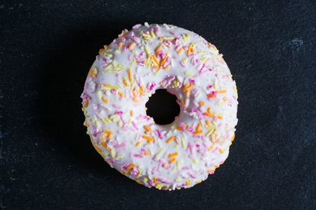Glazed white donut on shale dishes. Top View.の写真素材