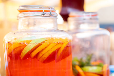 Natural juice made from fresh fruits. Drink at the bar in a glass jar on the street. Close up.の写真素材