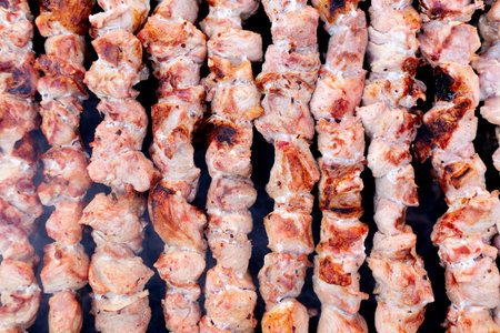 Tasty and juicy kebabs are cooked on charcoal. Concept of street photography. Top view. Background....