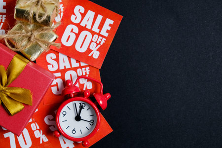 Vintage watch with gift boxes on red plates with discounts on a whatman paper in black. Christmas...