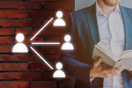 Leadership training. Icons of a man on the background of a man in a suit with a book. Concept.の写真素材