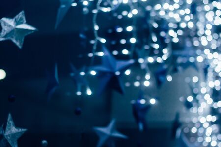 A beautiful blurry background of stars and blue, white lights. New Year's concept. Close up.の写真素材