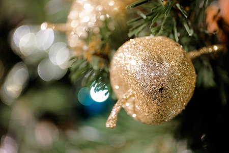 Decorated Christmas tree on blurred, sparkling and fairy background. Close up.の写真素材