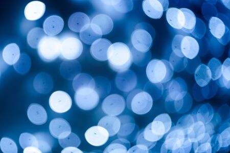 Beautiful saturated blurred blue and white lights. The concept of the New Year background.の写真素材