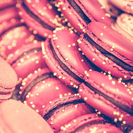 Delicious and beautiful pink macaroons on sale. Close up. square format, tonedの写真素材