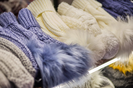 Woolly winter hats on the counter in the store. Close up.