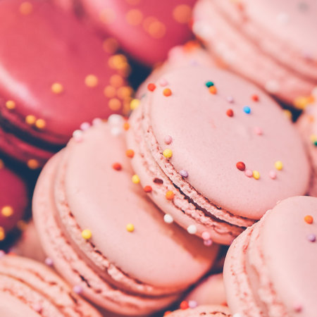 Delicious and beautiful macaroons on sale. Close up. square format, toned