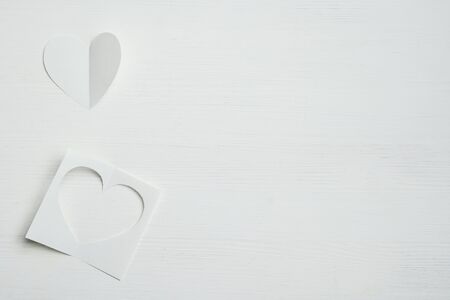 Paper abstract hearts on a white wooden background. copy space. Top view.の写真素材
