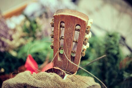 The old guitar. Concept of stopping making music. close up.の写真素材