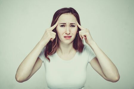Portrait of a girl in a white T-shirt suffering from psychological pressure and criticism of society. Close up. Toned.の写真素材