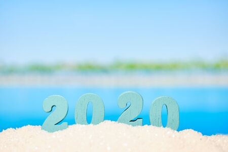 Beautiful blurred view of the beach and with numbers 2020 as a symbol of the year of vacation and travel. Close up.の写真素材
