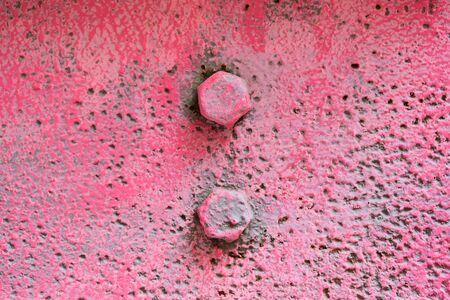 The texture of the metal is pink with bolts. Close up.の写真素材