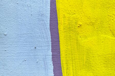 Abstract plaster texture of pale blue and yellow with a purple line. Close up.の写真素材