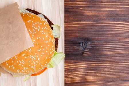 Burger top view from side on a wooden background. Close up.の写真素材