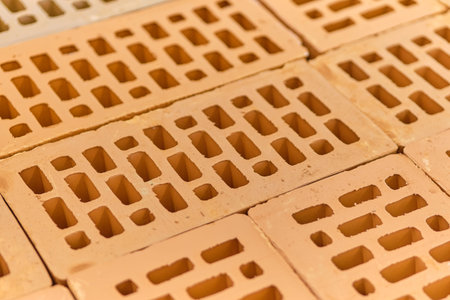Building material red brick with holes. Close up.