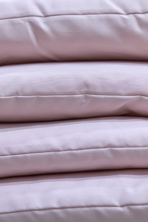 Modern purple pillows standing in a stack. Close up.の写真素材