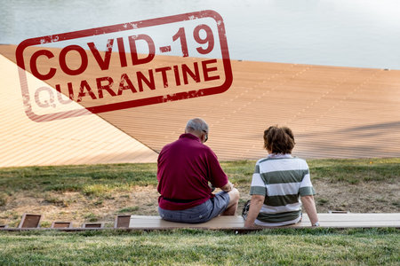 Abstract inscription - covid-19, quarantine against the background of the elderly in the park. Close...