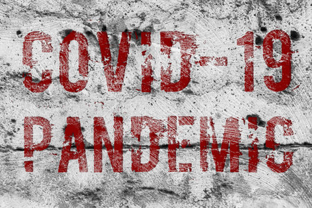 Concrete wall labeled pandemic OCVID-19 virus. Close up.