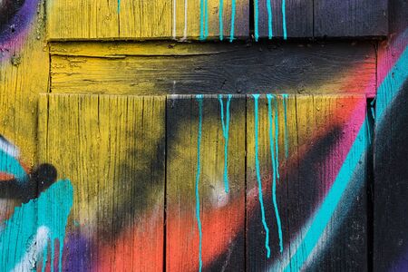 Wall wooden painted with different colors of paints. Close up.の写真素材