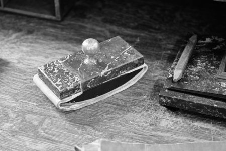 Paperweight on the table, black and white photo. Close up. Noise.