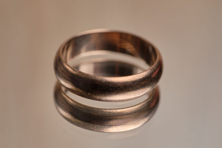 Golden ring on a glass table. Close up.